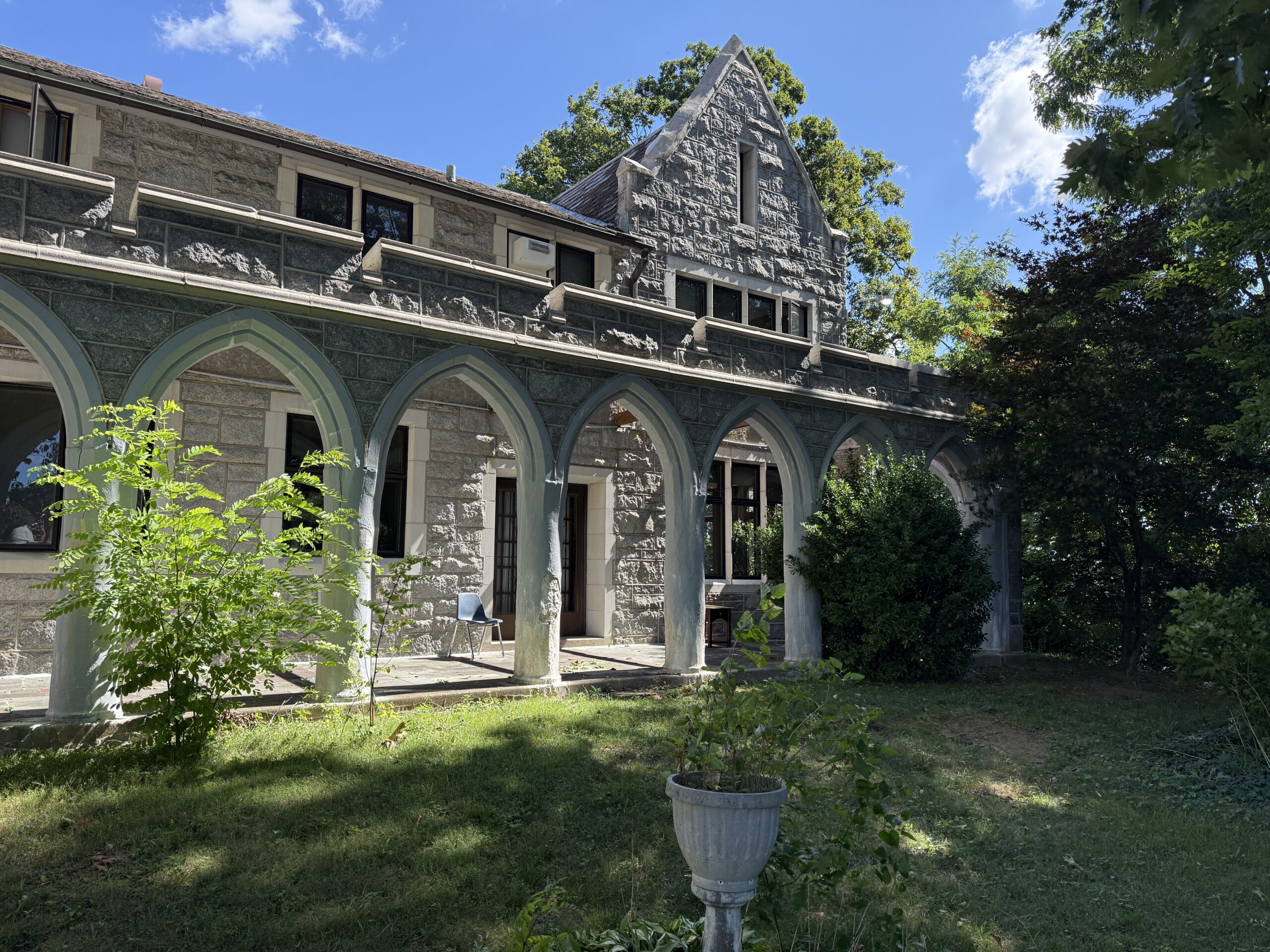 a stone religious building with columns and arches